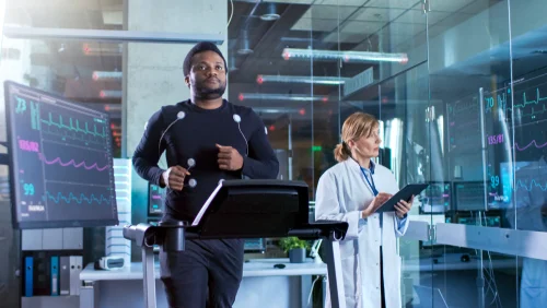A bright, modern rehabilitation gym with parallel bars and exercise equipment